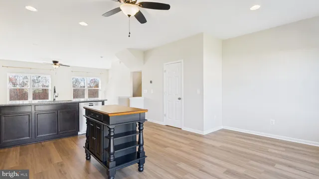 a kitchen with granite countertop a stove microwave and sink