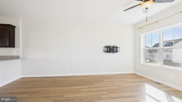 a view of a living room kitchen and a wooden floor