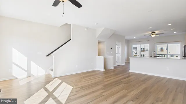 a view of a kitchen with wooden floor and staircase