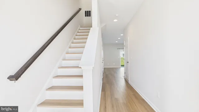 a view of a hallway with wooden shelves