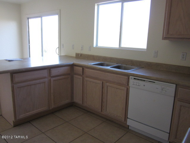 70 Círculo Cortez Rio Rico, AZ 85648 - Photo 8 of 13 a kitchen with a sink cabinets appliances and a window