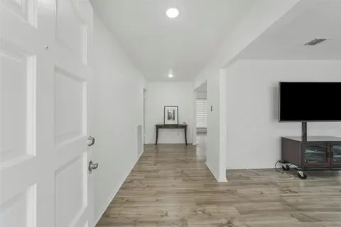 a view of a kitchen with wooden floor and windows