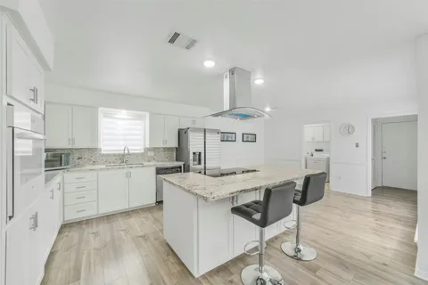 a kitchen with a sink and cabinets