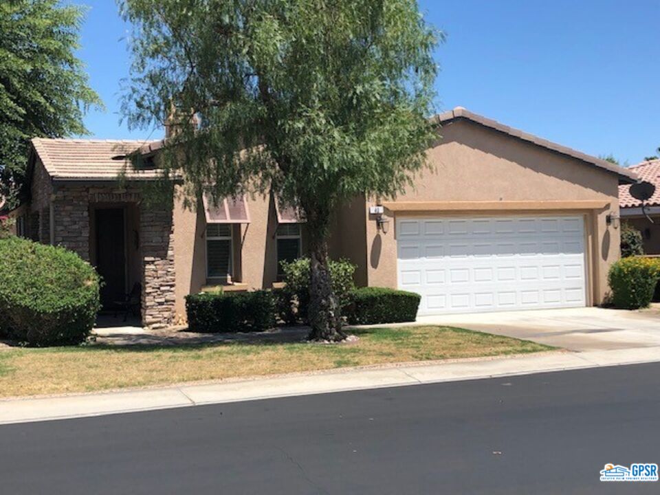 a house that has a tree in front of it