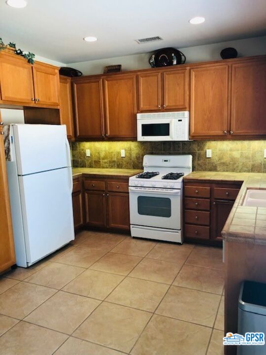 40 Shoreline Drive Rancho Mirage, CA 92270 - Photo 12 of 22 a kitchen with stainless steel appliances granite countertop a stove a sink and a refrigerator