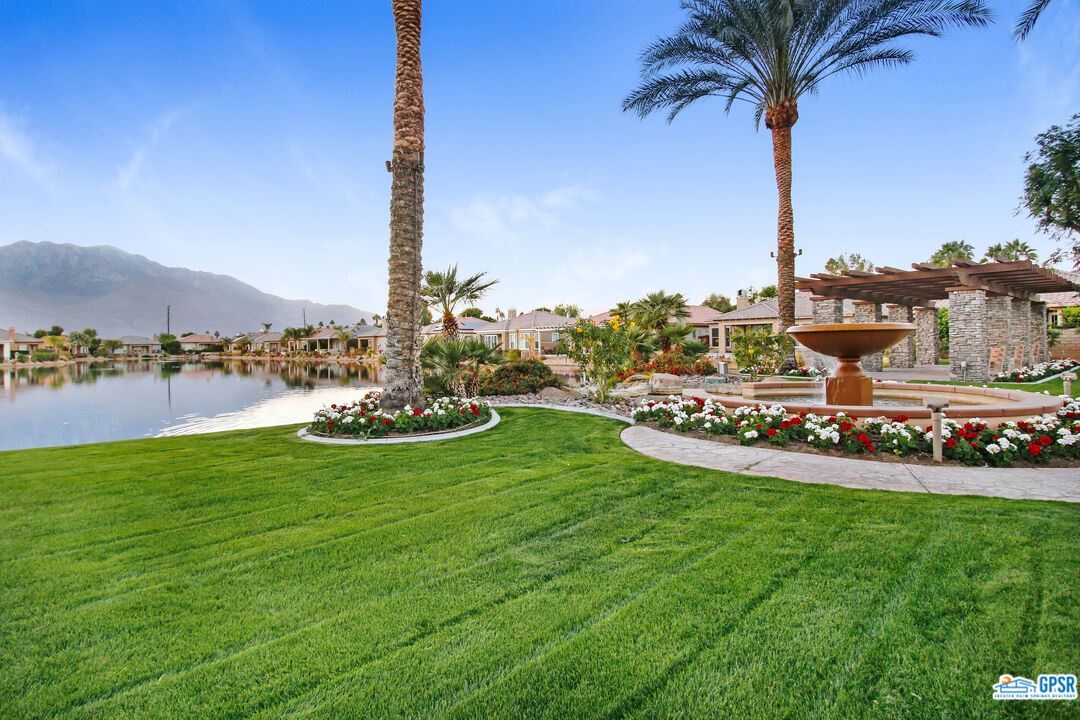 40 Shoreline Drive Rancho Mirage, CA 92270 - Photo 18 of 22 a view of a lake with a big yard and palm trees