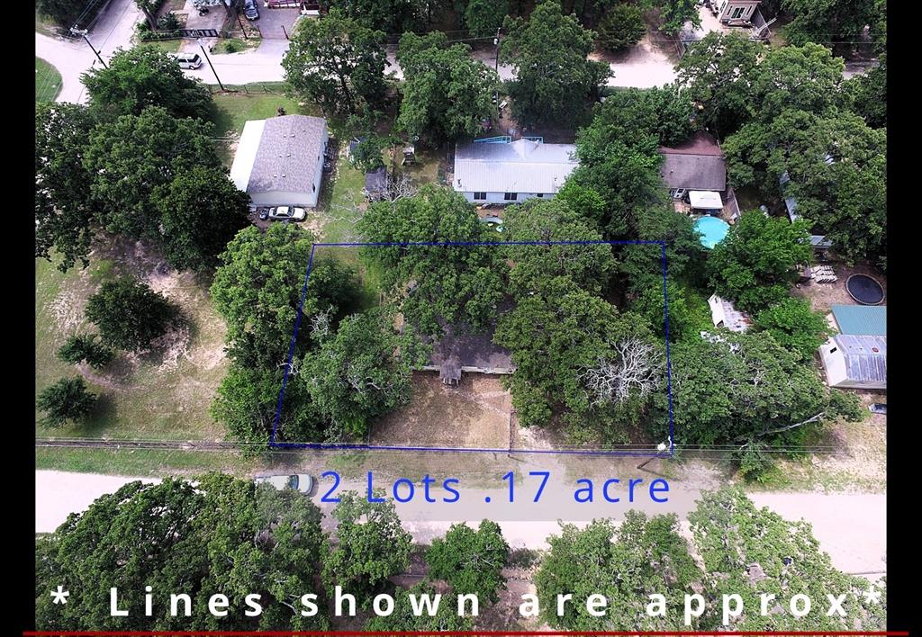 an outdoor space with seating area and trees all around