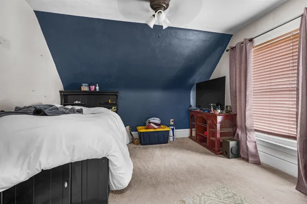 a bedroom with a bed and a chandelier