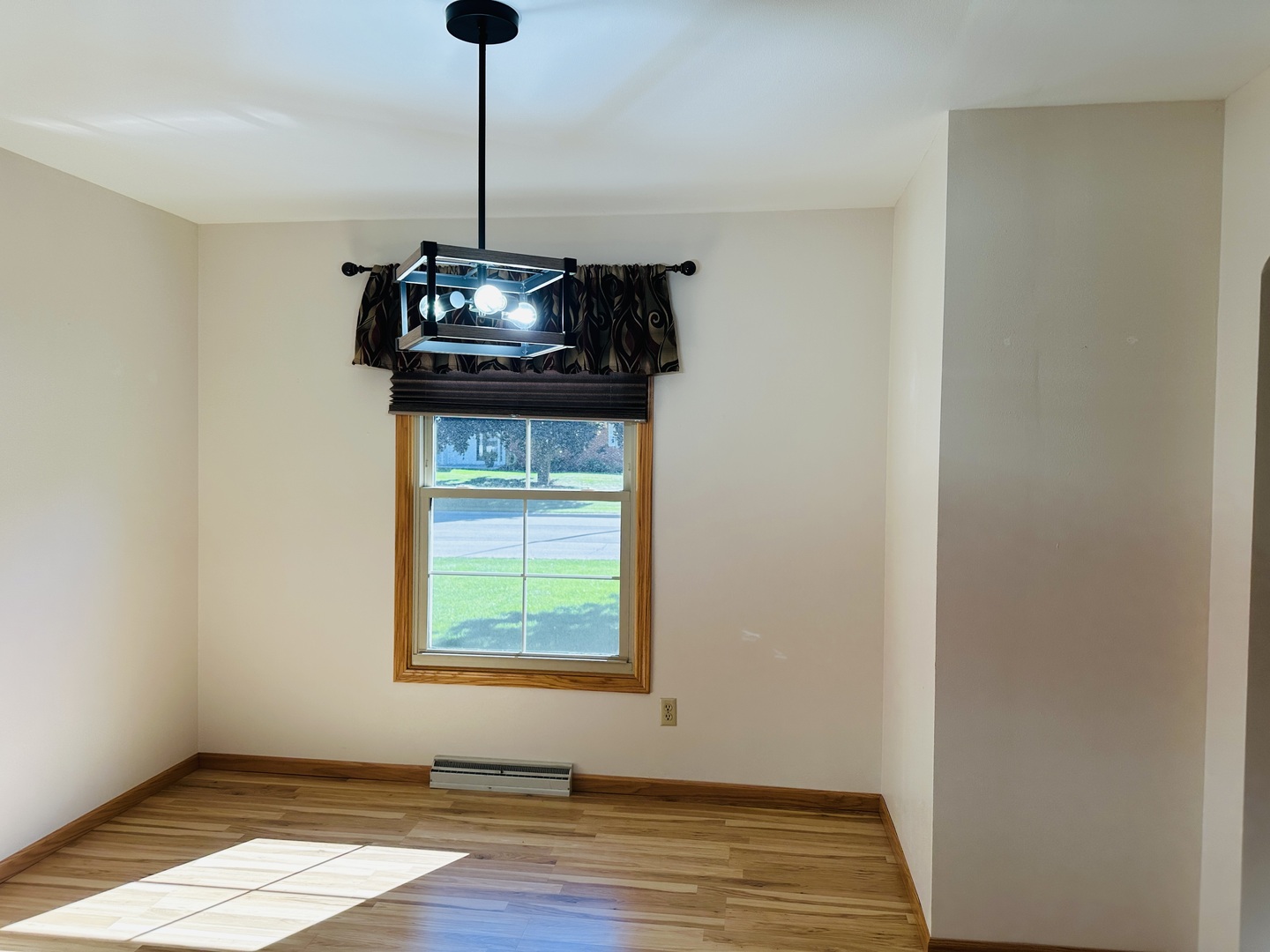 219 Palm Drive Lena, IL 61048 - Photo 11 of 50 a dining room with a window and wooden floor