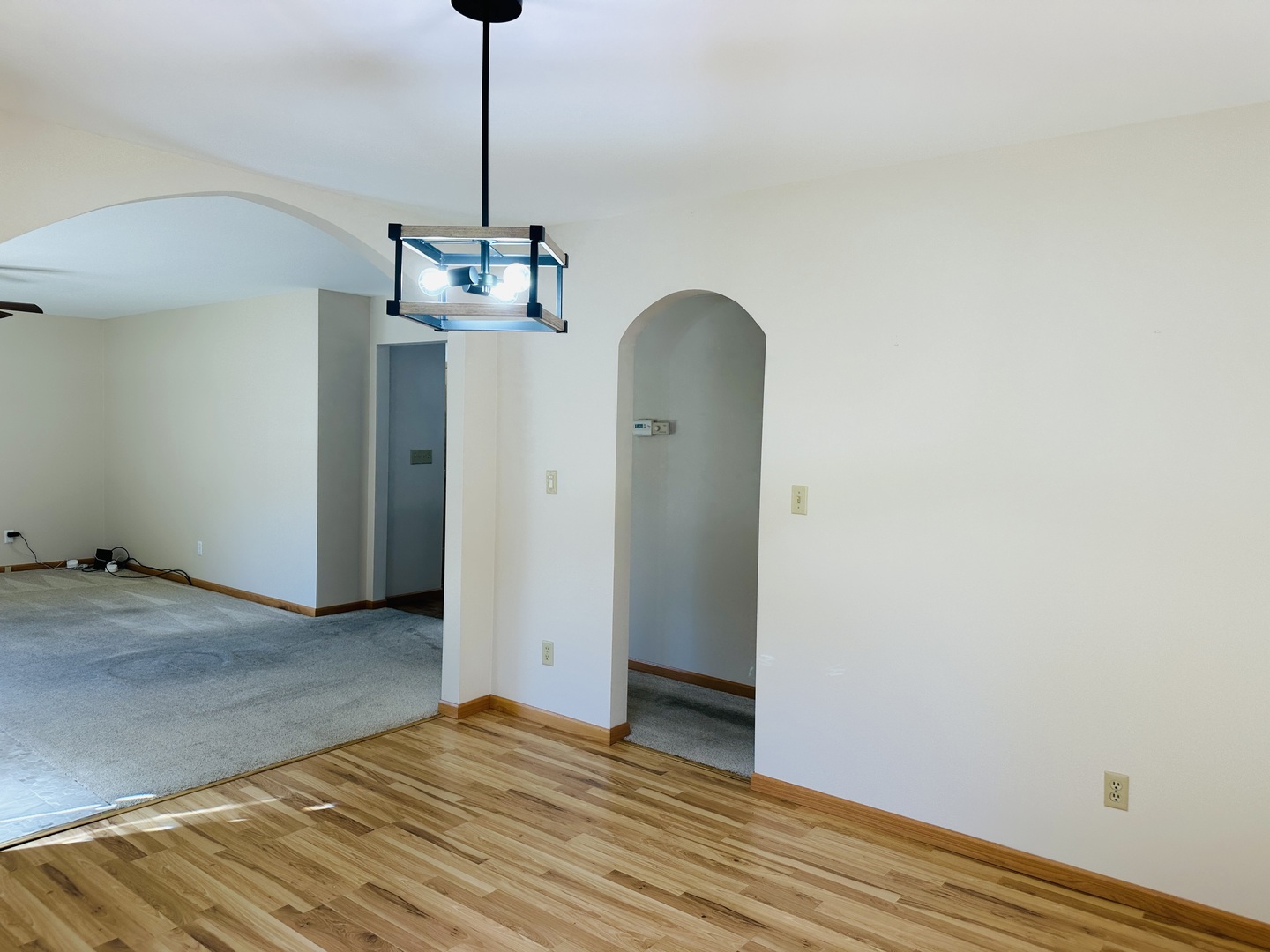 219 Palm Drive Lena, IL 61048 - Photo 13 of 50 a view of a room with wooden floor and chandelier