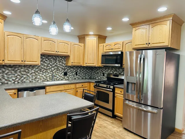 a kitchen with a refrigerator and a sink