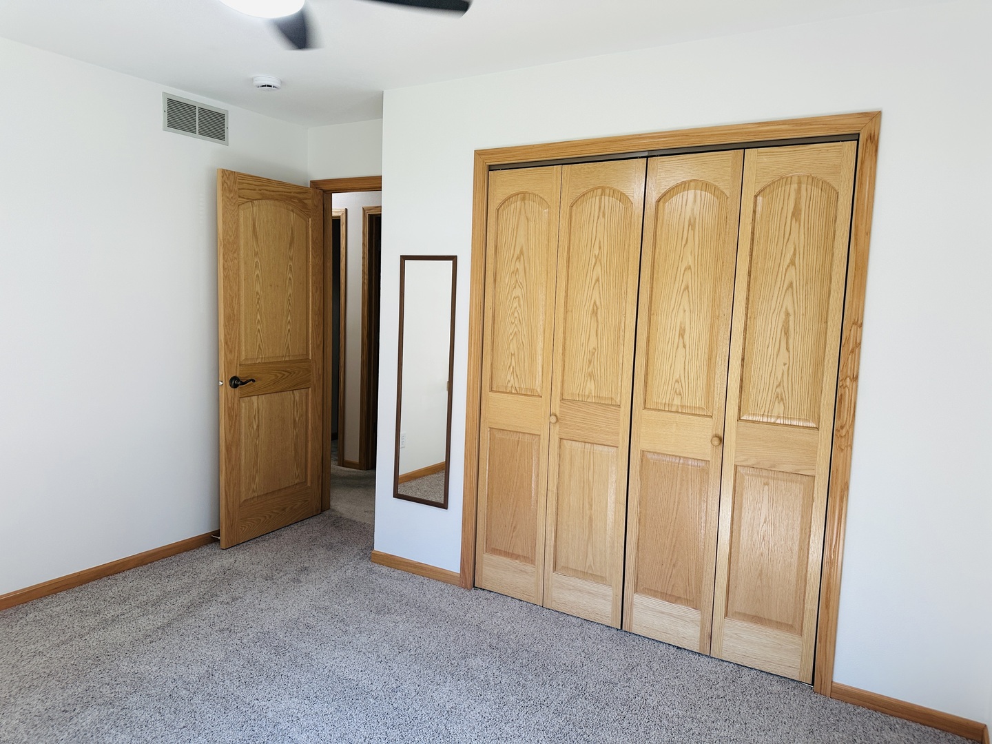219 Palm Drive Lena, IL 61048 - Photo 29 of 50 an empty room with wooden floor and a window