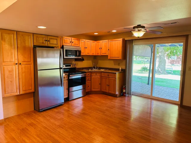 a kitchen with stainless steel appliances a stove a sink and a refrigerator