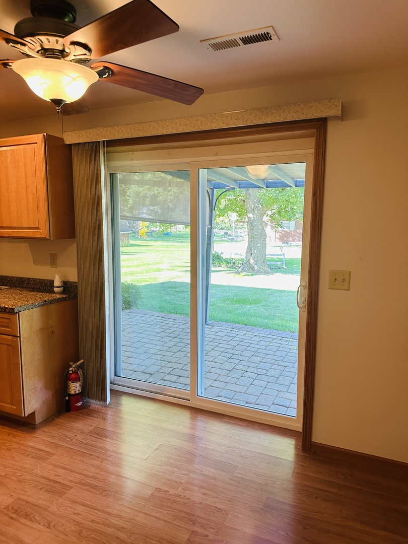 219 Palm Drive Lena, IL 61048 - Photo 42 of 50 a view of an empty room with wooden floor and a window