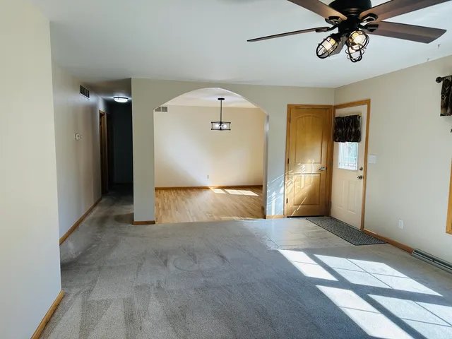 a view of room with a ceiling fan and window
