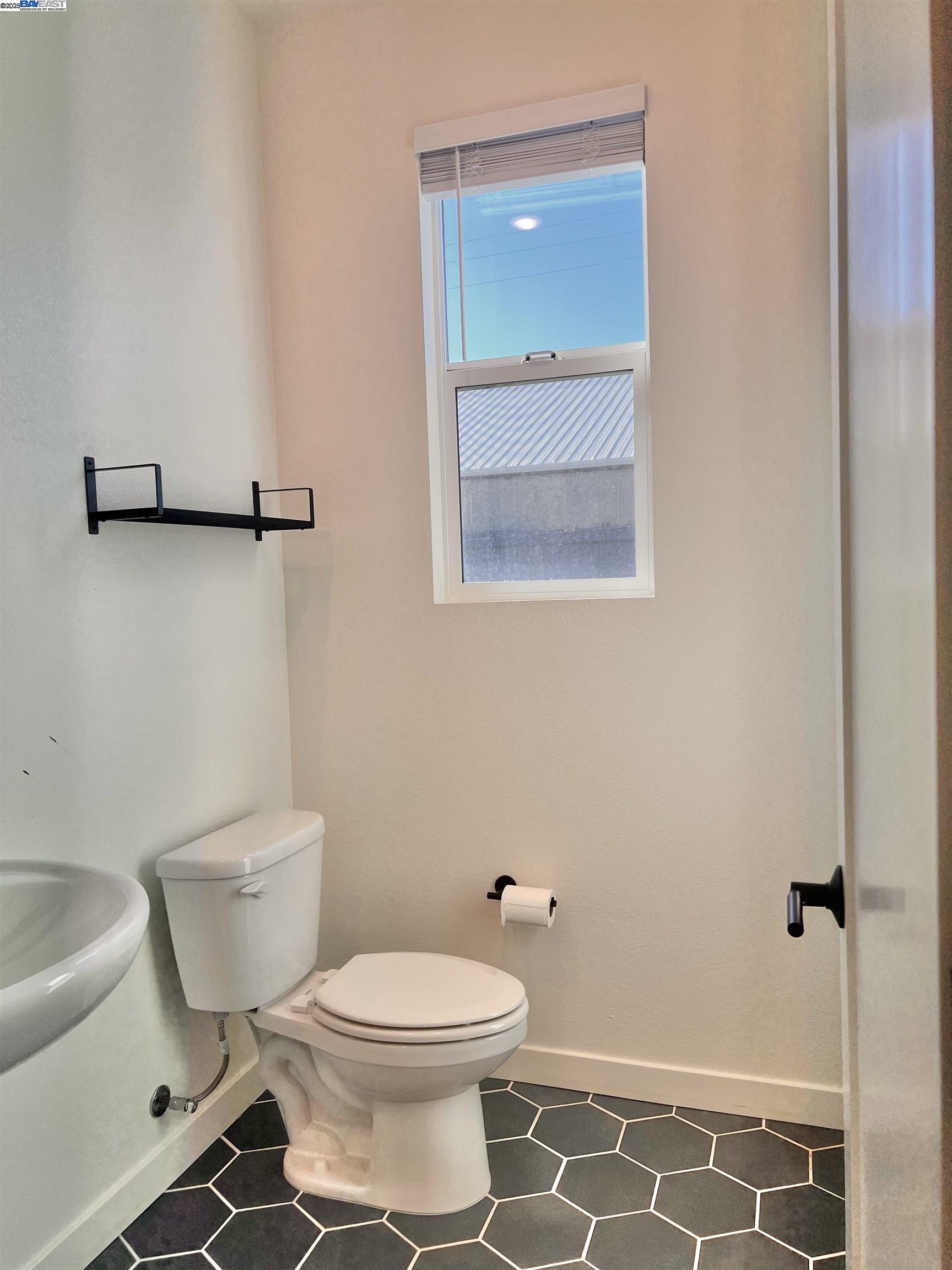 1712 17th Street Oakland, CA 94607 - Photo 17 of 31 a bathroom with a toilet and a shower