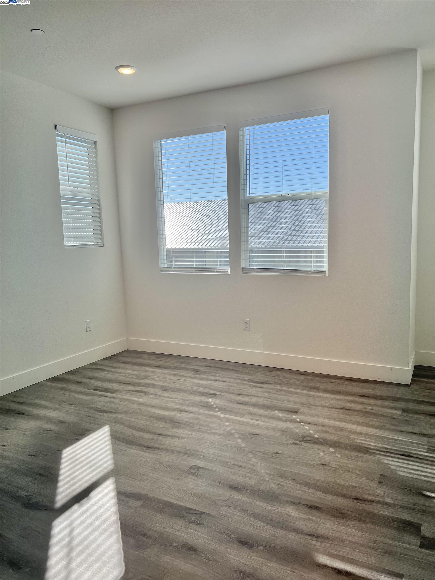 1712 17th Street Oakland, CA 94607 - Photo 19 of 31 a view of an empty room with wooden floor and a window