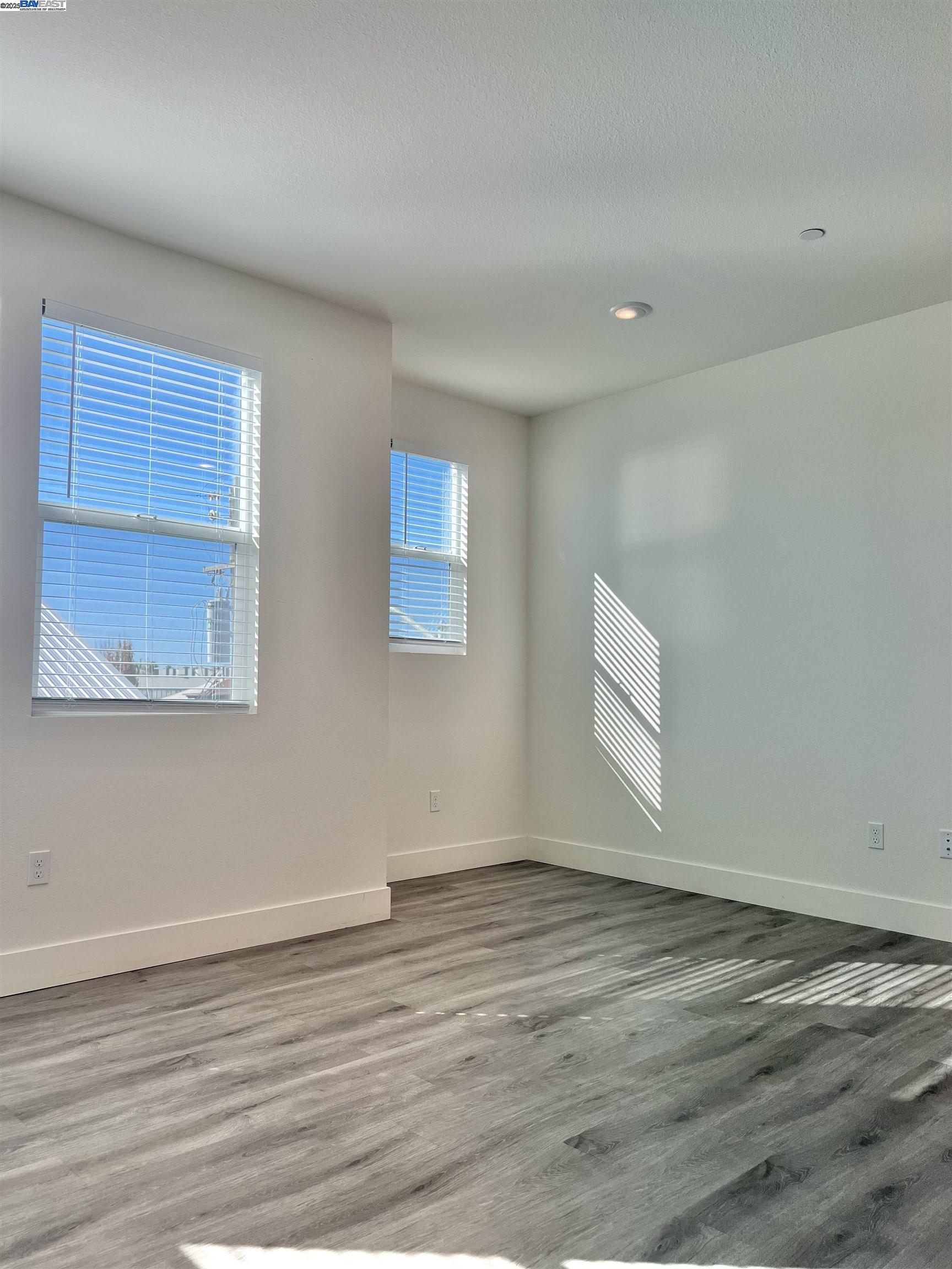1712 17th Street Oakland, CA 94607 - Photo 22 of 31 a view of an empty room with wooden floor and a window
