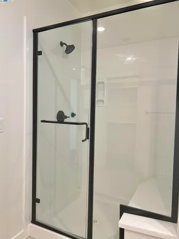 a bathroom with a glass shower door