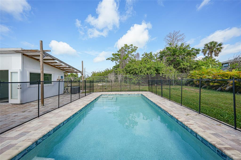 8164 Archie Street Englewood, FL 34224 - Photo 32 of 42 a view of a backyard with swimming pool