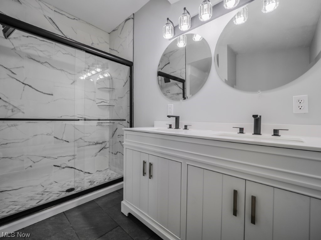39330 Chestnut Ridge Road Elyria, OH 44035 - Photo 15 of 32 Bathroom with dual bowl vanity, tiled shower, tile flooring, and mirror