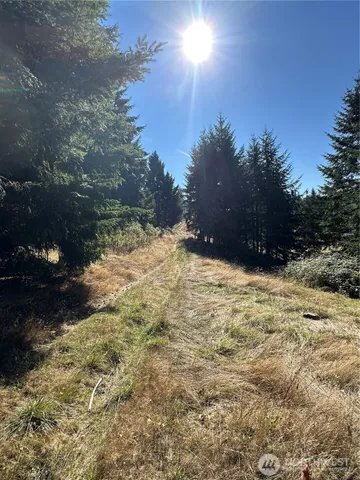 a view of a small house with wooden fence