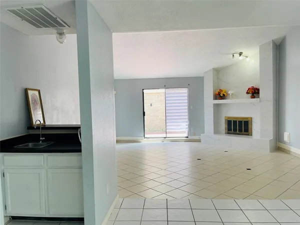 a kitchen with granite countertop a sink stove top oven and cabinets