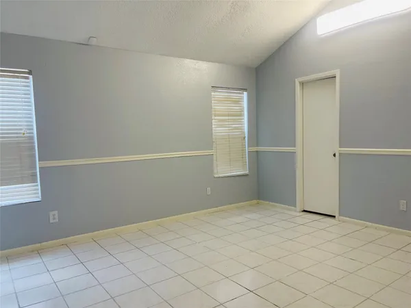 a bath room with a sink and mirror with bathtub