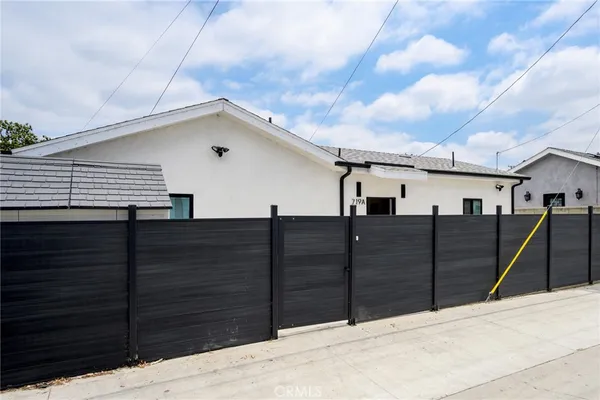 a house view with wooden fence