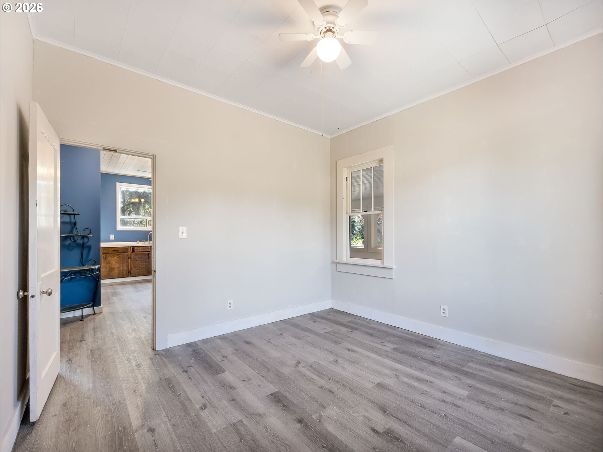 36290 7th Street Nehalem, OR 97131 - Photo 19 of 38 wooden floor in an empty room with a window