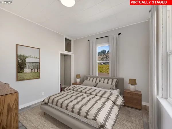 a bedroom with a bed and painting on the wall