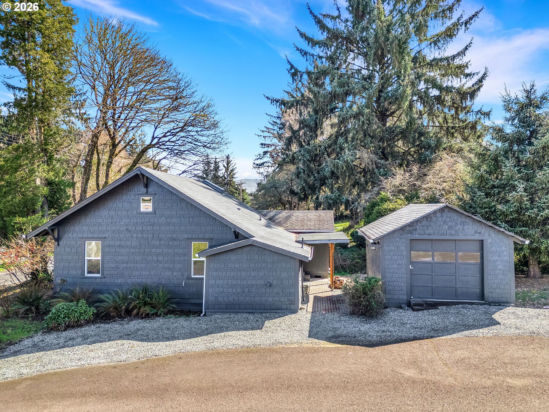 36290 7th Street Nehalem, OR 97131 - Photo 33 of 38 a front view of a house with a yard and garage