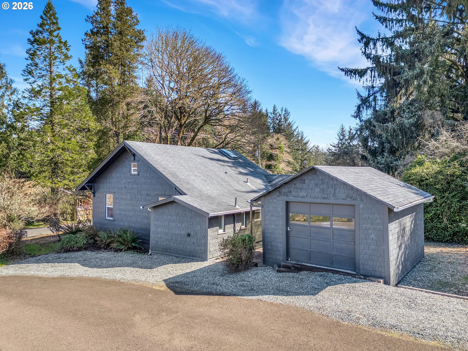 36290 7th Street Nehalem, OR 97131 - Photo 34 of 38 a front view of a house with a yard and garage