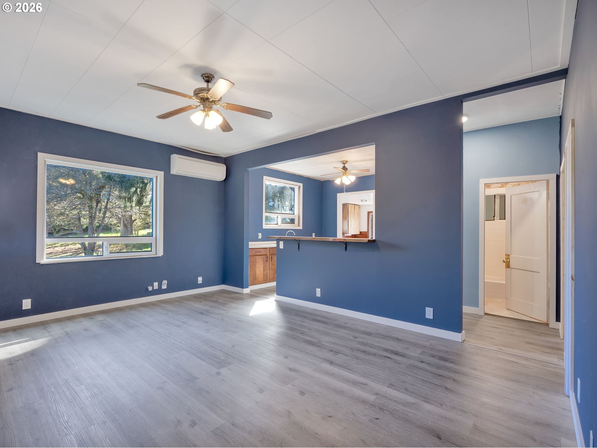 36290 7th Street Nehalem, OR 97131 - Photo 6 of 38 a view of an empty room with window and wooden floor