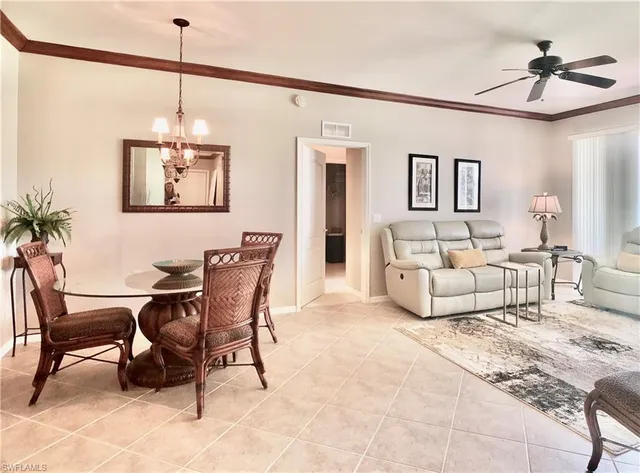 a view of a livingroom with furniture and a ceiling fan