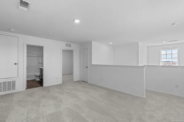 a view of an empty room and a window