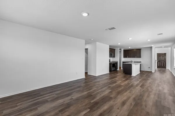 a view of a kitchen with wooden floor