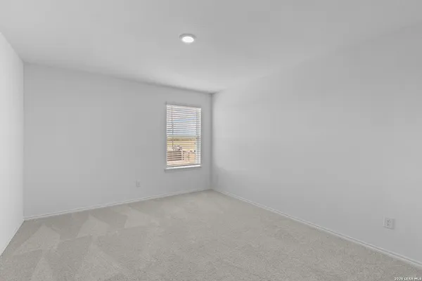 a view of an empty room and a window