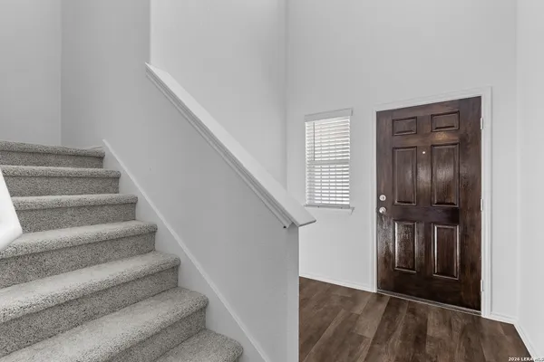 a view of entryway and hall with wooden floor
