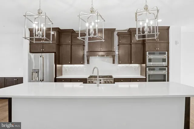 a view of kitchen with refrigerator and microwave