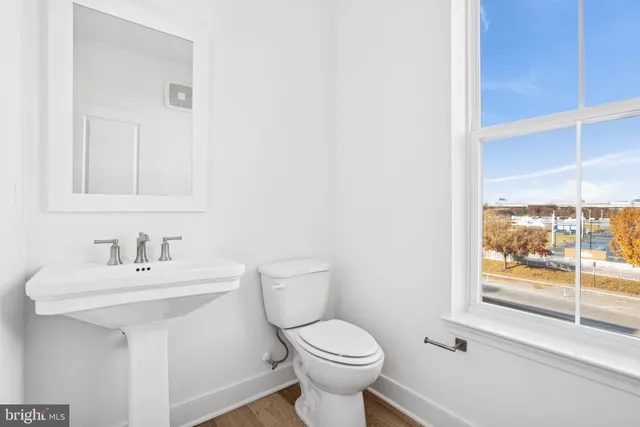 a bathroom with a sink toilet and a mirror