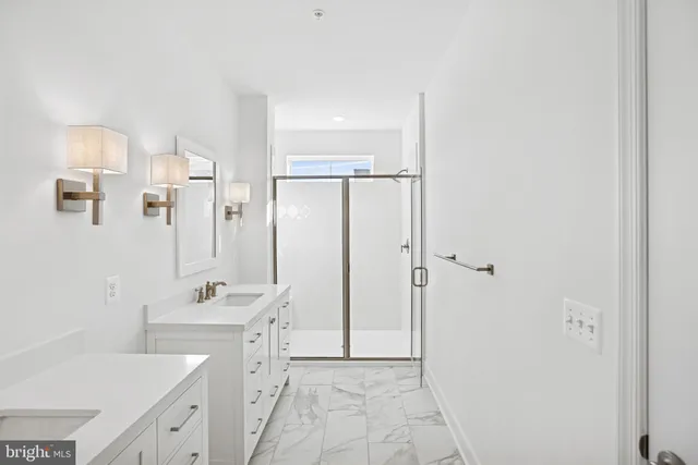 a bathroom with a tub sink a mirror and a shower