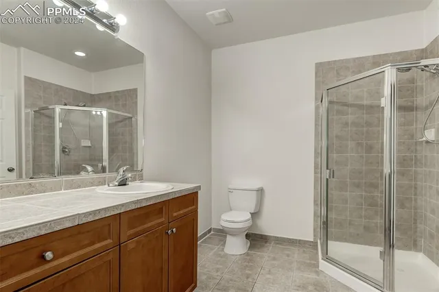 a bathroom with a double vanity sink toilet and shower