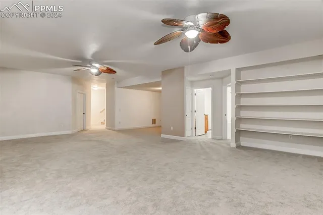 a view of empty room with ceiling fan