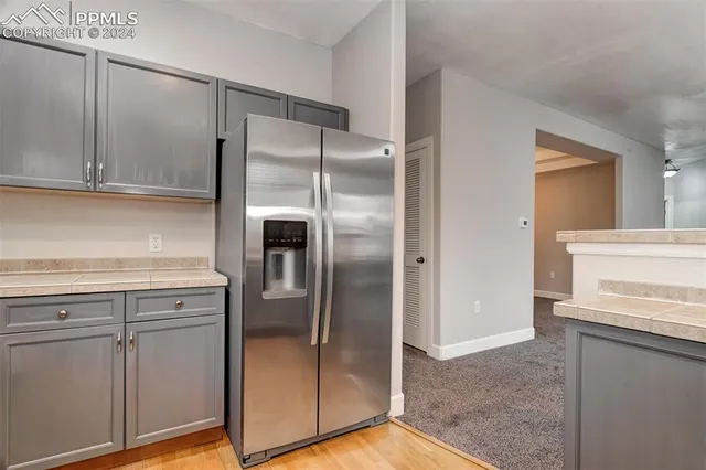 a kitchen with a refrigerator and a sink