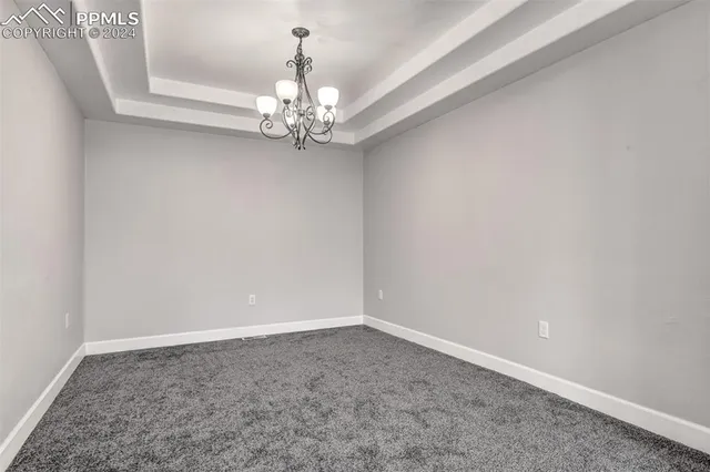 en empty room with chandelier fan