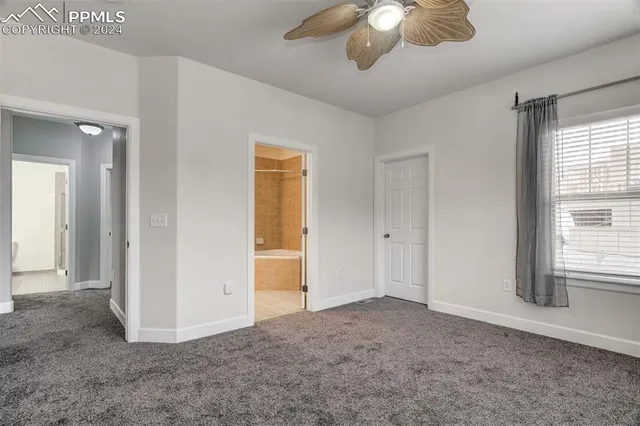 a view of a livingroom with a ceiling fan and window