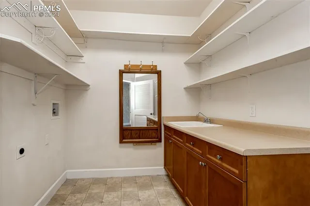 a kitchen with a sink and a refrigerator