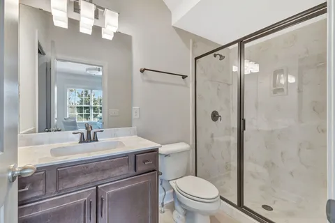 a living room with furniture kitchen view and a wooden floor