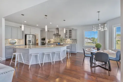 a kitchen with stainless steel appliances granite countertop a refrigerator and a stove top oven
